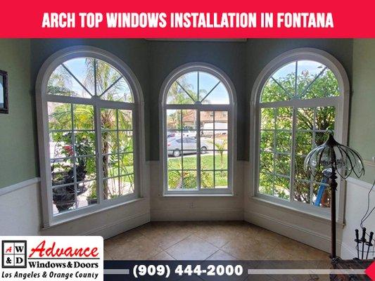 Fontana window installation with a trio of arch top windows and sliders below.