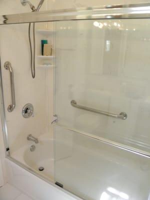 A thoroughly modern look and ease of maintenance has been and still is Cultured Marble. Here in white on white with grab bars.