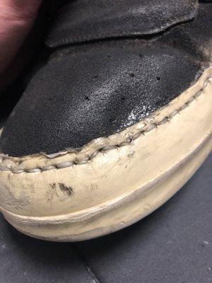 Crooked stitching and glue stains on toebox