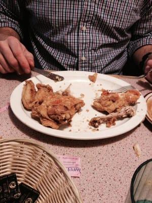 Half eaten 1/2 fried chicken.