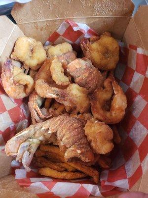 Container with fried shrimp and lobster tail.