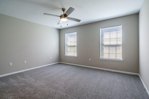 Lancaster Place Apartments in Calera, Alabama photo of a bedroom with 2 windows.