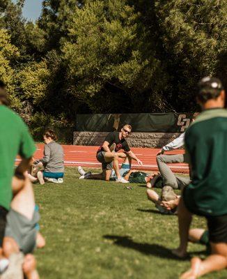 Mike leading a recovery/partner stretching session with the Cal Poly Rugby team.