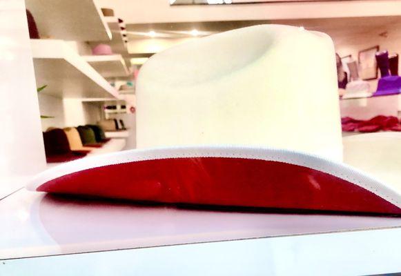 Red inside the hat, simulates Christian Louboutin red bottom heels..FYI Christian shop is conveniently next door!