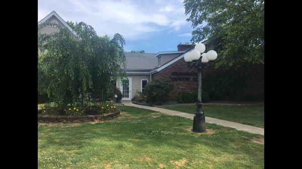 This is the outside of the restaurant. It is located on a golf course.