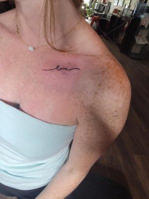 Love tattoo under collar bone by Caesar