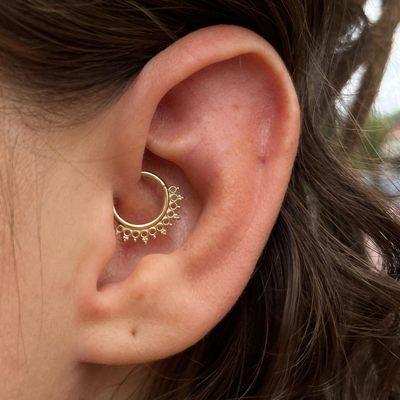 Daith piercing featuring an IRIS exclusive jewelry design from Shiva. This piecing was performed by Kenzie in Grand Rapids!