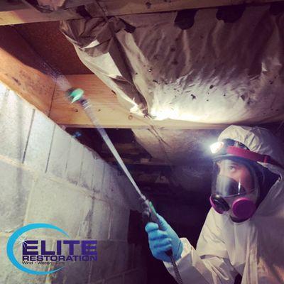 Mold treatment in a residential crawl space.