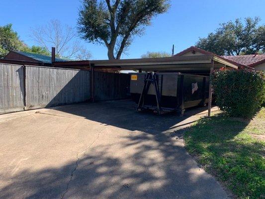 30 yard. Home renovation before a rain. Not a problem. Expert driver fit container under carport for ease of dry loading in wet conditions.