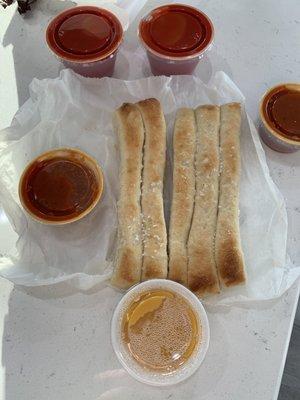 5 skinny breadsticks with nacho cheese, 2 marinaras, and 2 monicals sweet and tart dressing are pictured.