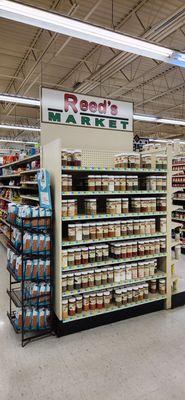 Rack of coffee and shelves of spices & BBQ rubs.