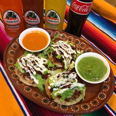 3 small fried tortillas topped with refried pinto beans the choice of meat, lettuce, crema and cotija. Choice of green or red sauce.