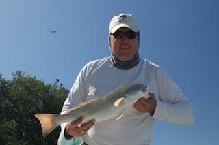 Denver Bronco superstar Mark Cooper shows off his redfish caught during the Redbone Tournament