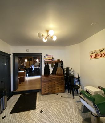 Room between the front (barber shop) and back (bar area).