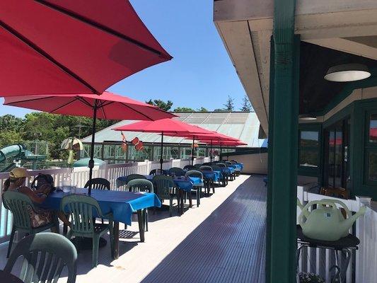 Outdoor dining overlooking two of our pool and scenic Deer Lake.