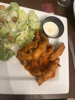 Tenders platter tossed in buffalo sauce with a side caesar salad.