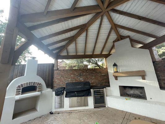 Hip pavilion with a fireplace, outdoor kitchen and pizza oven