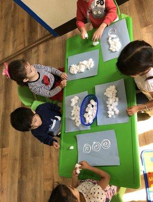 Making a cotton snowman! Excellent for their fine motor skills.