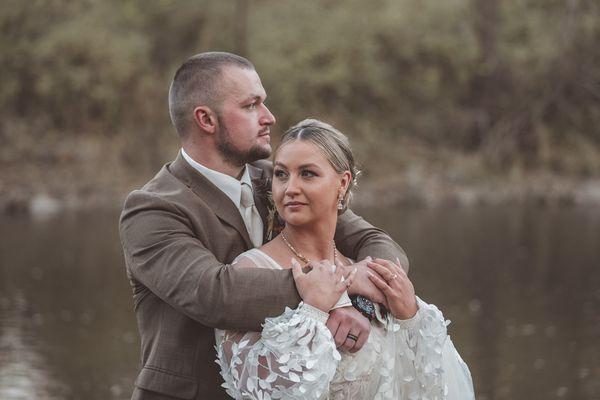 Couple standing next to a creek