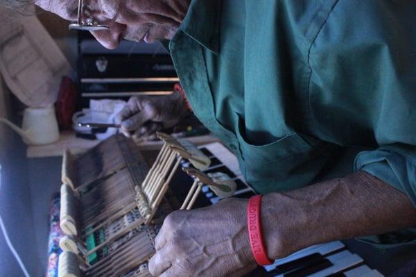 John Grigo repairing a piano.