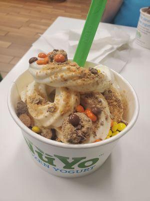 Cookies and cream froyo on the bottom and cake batter on top. Topped w/ butterfinger, reeses pieces, and snickers candies. Lol