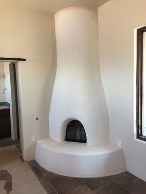 An authentic kiva fireplace with diamond plaster finish.