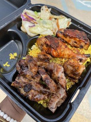 Combination platter with jerk chicken & pork w/ island rice and cabbage.