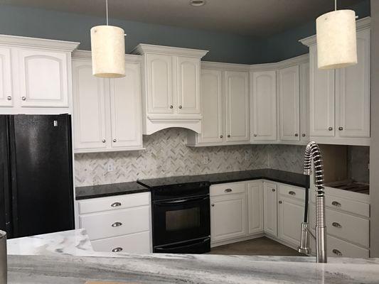 Kitchen refinished in white.  Was previously a dark stain