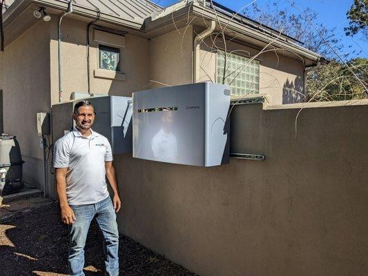 Adolfo next to one of the Enphase battery backup systems we installed.