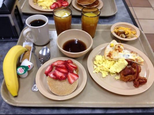 Pancakes w/ strawberries. Bacon, eggs, potato slices & breakfast pizza  oj & coffee