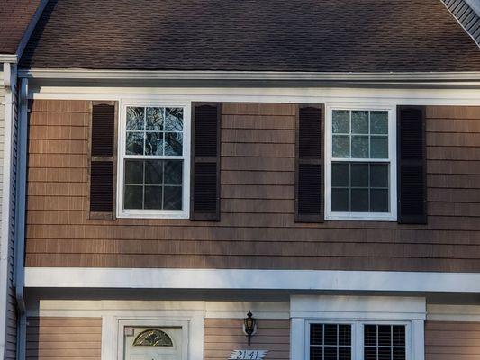 Replaced the old cedar shake second floor siding with shaker look vinyl siding, vapor barrier, new windows and repainted shutters.