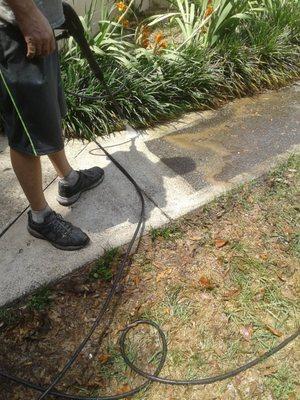 Pressure washing the sidewalk