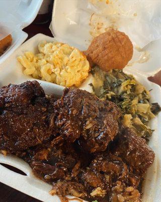 Oxtails, macaroni and cheese, collard greens and cabbage mix