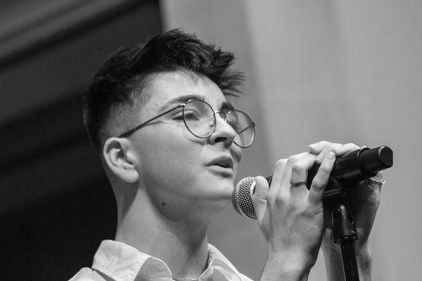 Oliver (He/Him) croons "Can't Help Falling In Love With You" at the Spring 2024 Recital. Photo by Queer Lenz Photography.