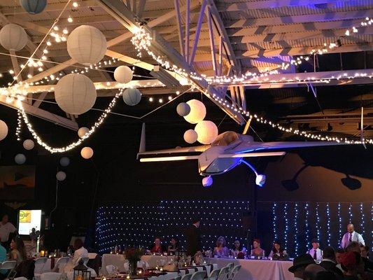 This used to be an airplane hangar...and then became transformed into a beautiful, lit up and intimate space for our wedding