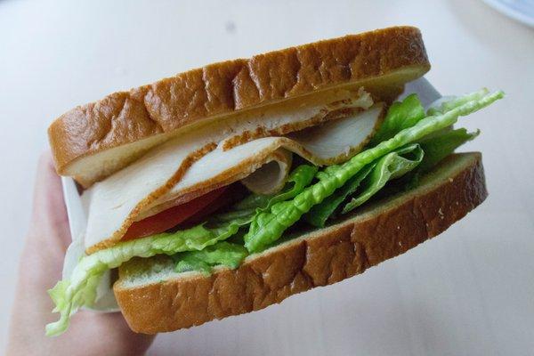 Turkey, Lettuce, and Avocado Sandwich on two lightly toasted slices of White Bread (exchanged Cheese and Mayo for extra Lettuce)