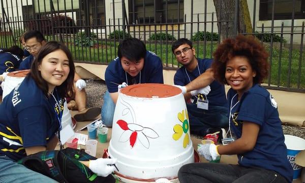 Volunteers from Prudential create beautiful planters to brighten up the exterior of a Newark school.