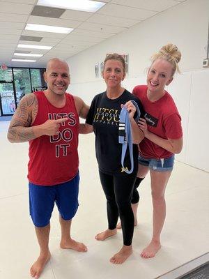 Getting two stripes on my blue belt from Coaches Danilo and Jessica Cherman.