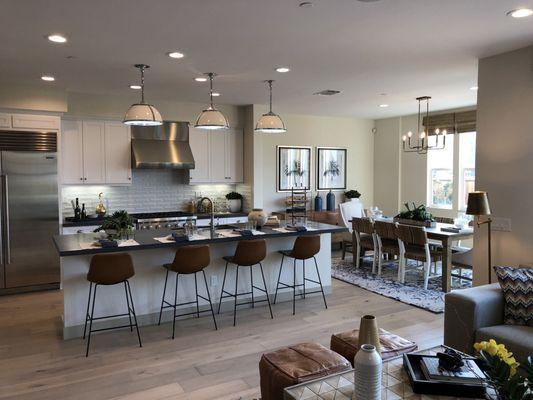 Amazing kitchen with hardwood floors, quartz countertops and tile backsplash.