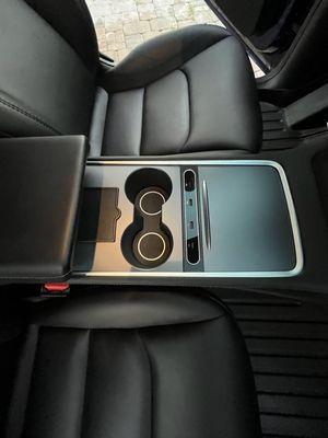 Front cupholder area in Tesla entirely streak-free finish. Full detail package.