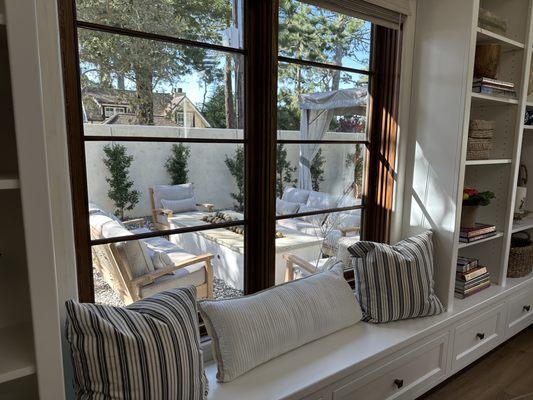 A view from inside showing the new outdoor patio furniture around a built-in firepit.