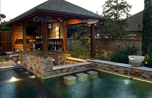 Outdoor bar cabana water feature into pool