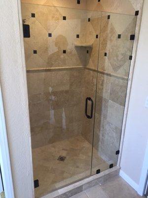 3/8 Frameless Shower enclosure with Oil Rubbed Bronze hardware to go with the tile pieces in the Shower. Another Happy Customer!