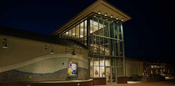 The glass tower and fountain at night.