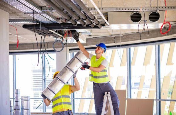 Ductwork installation by two team members in down town Miami