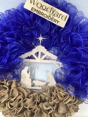 Lighted nativity wreath. Handcrafted and accented with a wooden nativity scene in the middle cut with a laser machine.