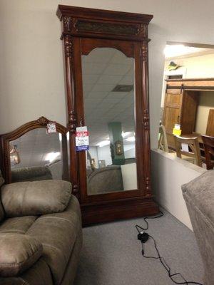 Jewelry cabinet with mirror.  This leans on the wall or can be attached.