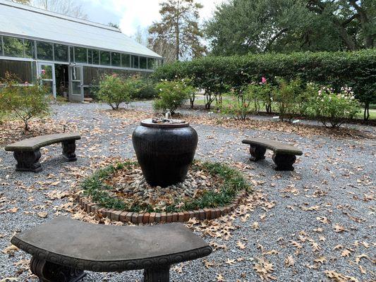 Beautiful fountain near the roses