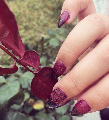 These are color changing acrylics and she created gorgeous flowers on my middle nail with acrylic as well