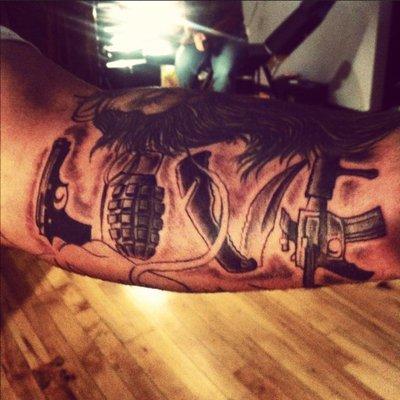 Grenade and weapons tattoo by Ben Lashley